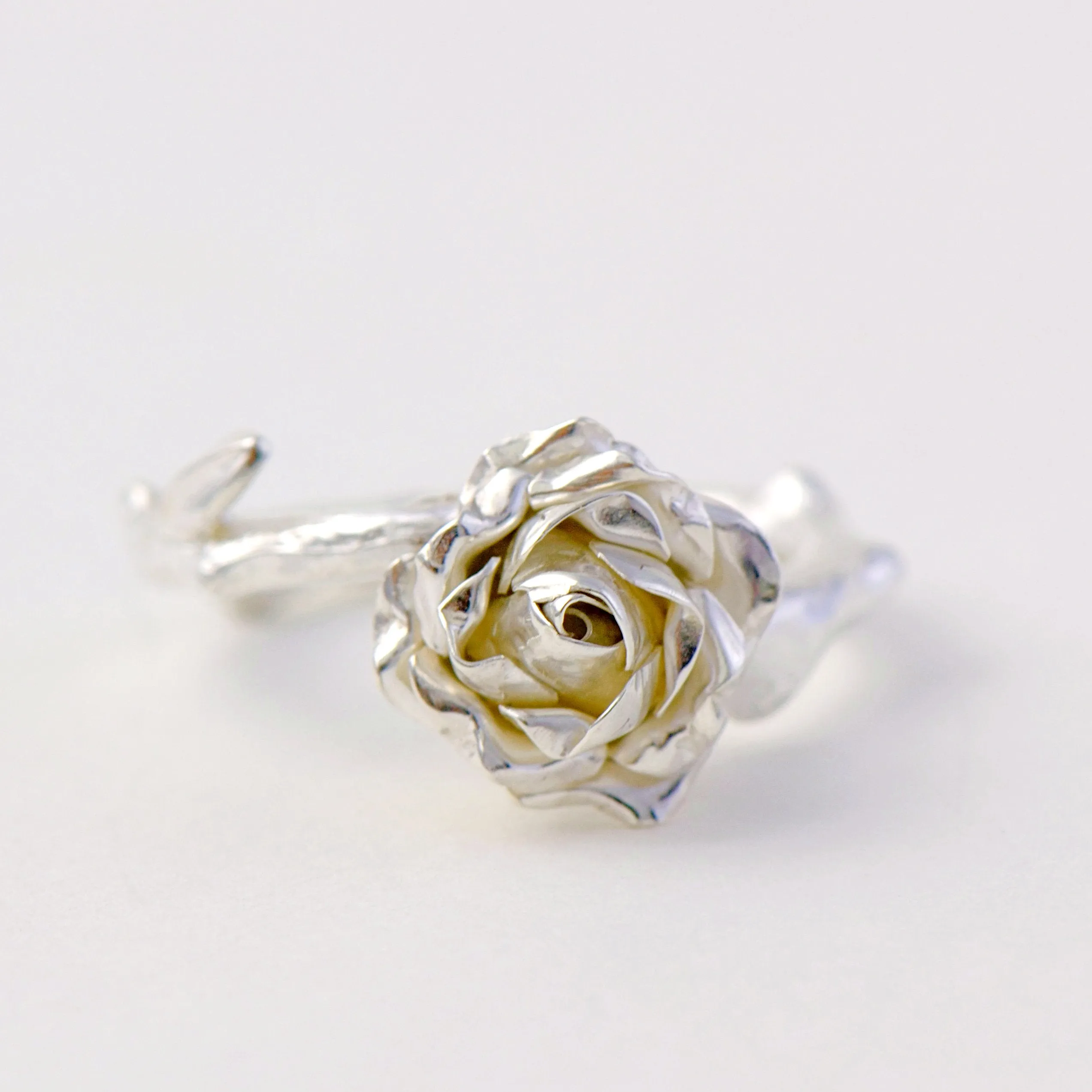 Delicate, small rose ring with a soft rose stem