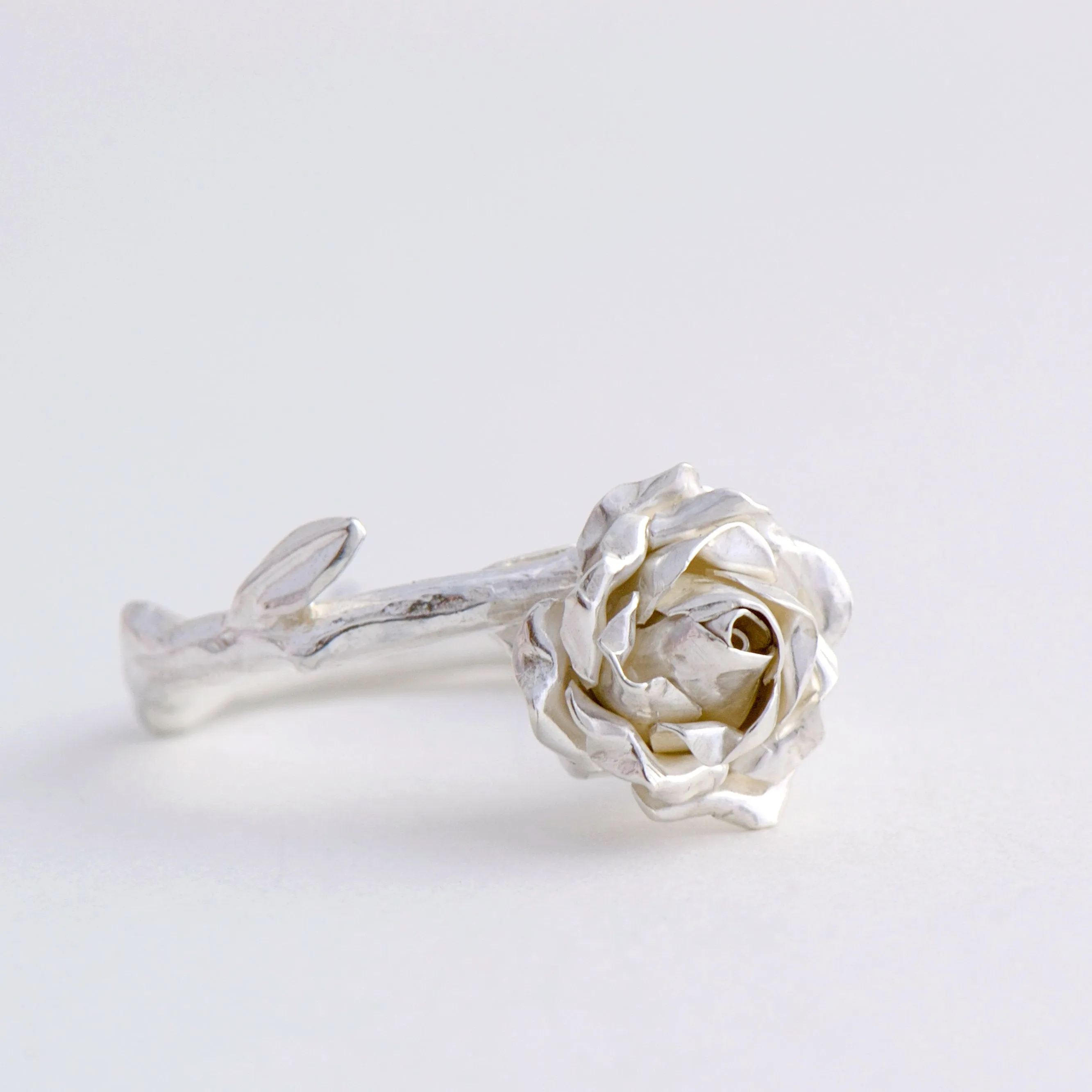 Delicate, small rose ring with a soft rose stem