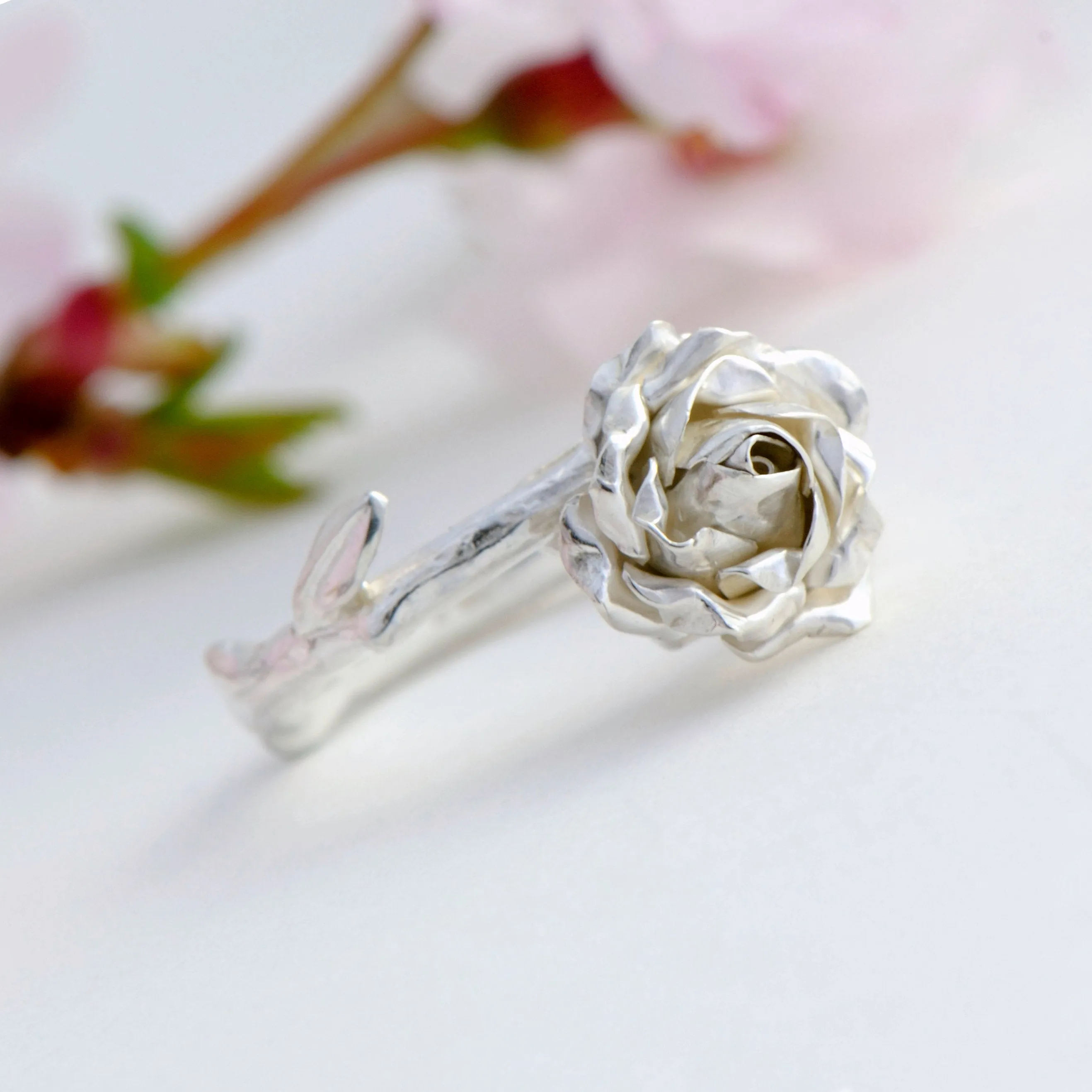 Delicate, small rose ring with a soft rose stem