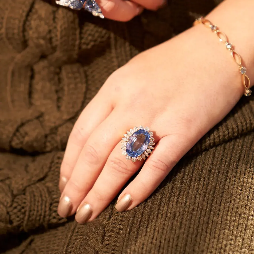 Large Oval Blue Sapphire with Round and Marquise Diamond Halo Style Ring
